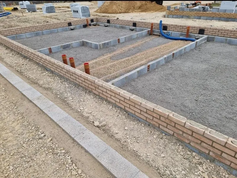 Blockwork footings with drainage pipes set in
