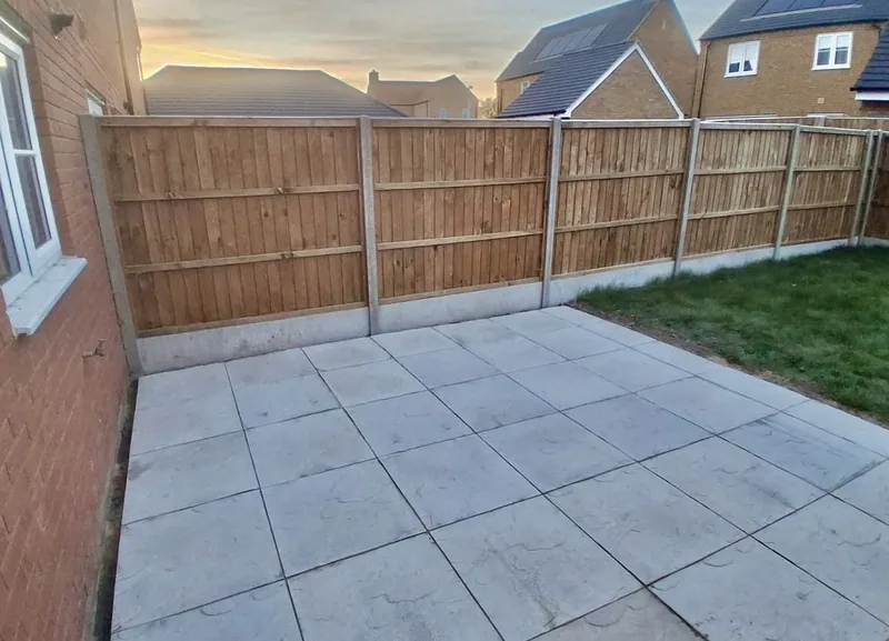 A slab patio in front of a new closeboard fence