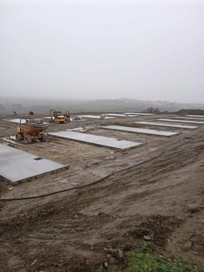 Concrete pads poured in rows across a new site